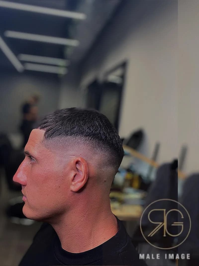 Men's fade haircut with textured top