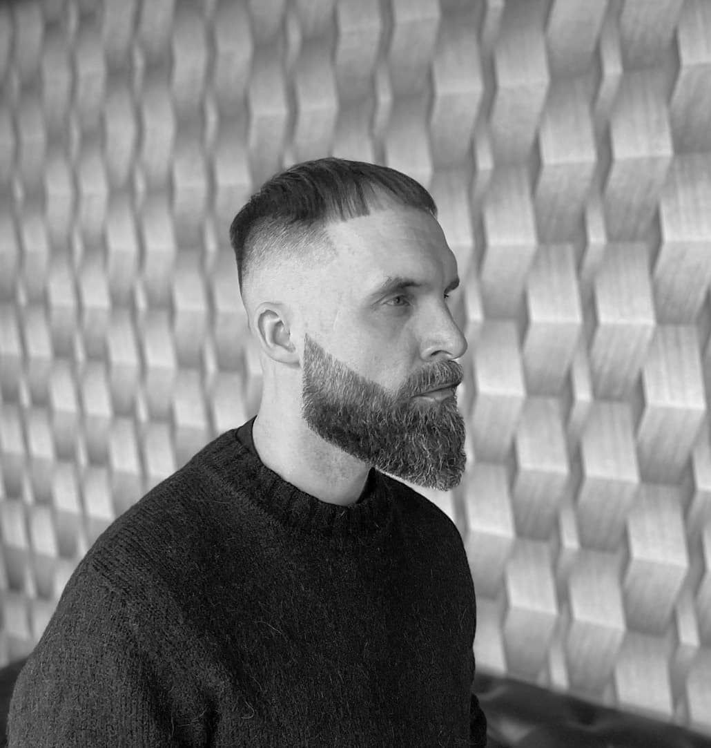 Men's haircut with high skin fade and full beard